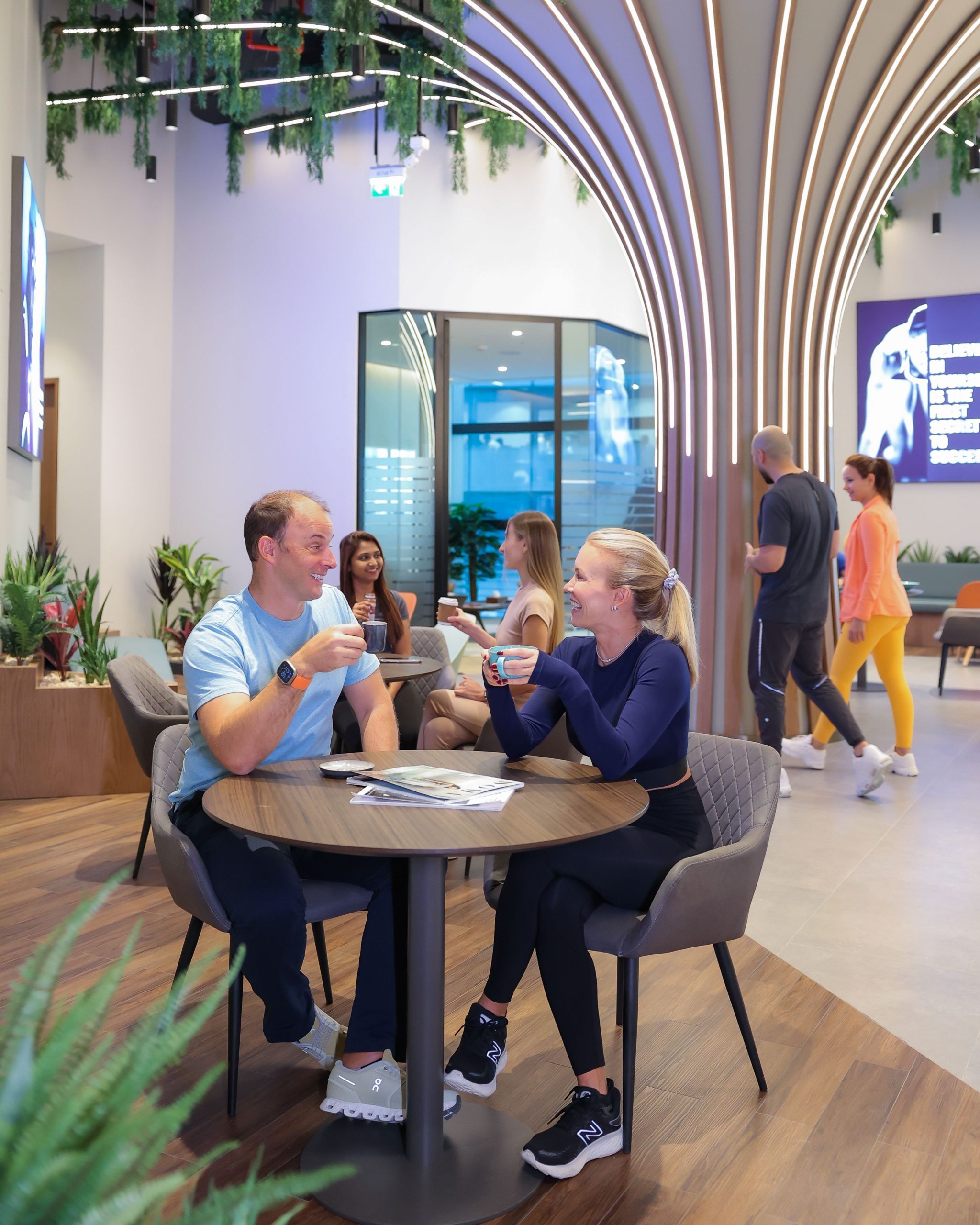 a couple is having coffees at embody fitness cafe